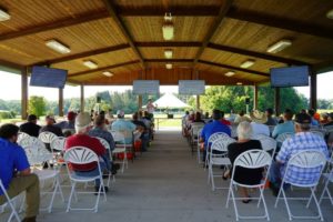 Previous Steak and Potato Field Day Presentation with attendees under new program shelter.