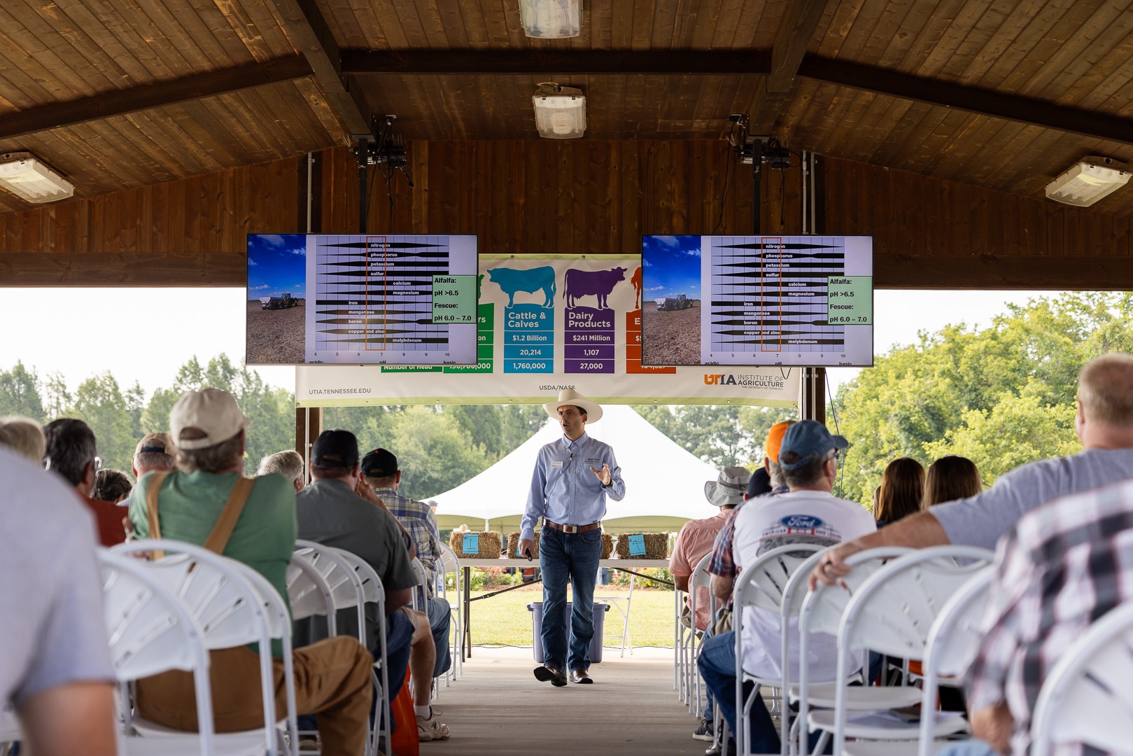 Presenter inside pavilion at 2024 Steak and Potatoes Field Day