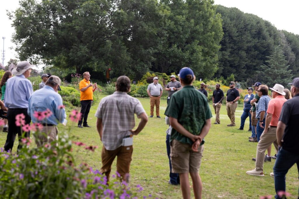 Participants listening to a presentation being delivered in the UT Gardens, Knoxville in 2025