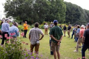 Participants listening to a presentation being delivered in the UT Gardens, Knoxville in 2025